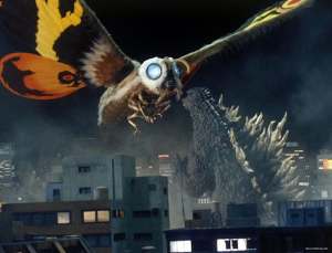 A still from the film Godzilla: Tokyo SOS. Mothra uses a beam attack while flying over a Japanese cityscape.