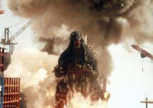 A frame from the film Godzilla: Tokyo SOS. Godzilla faces the viewer, as explosions go off around him.