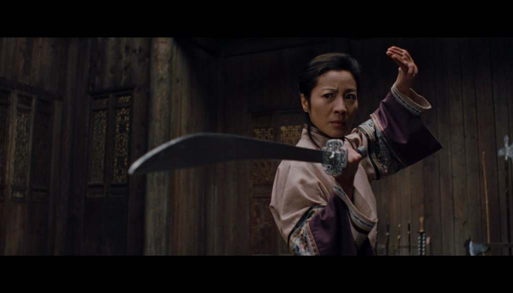 Actress Michelle Yeoh dons a sword in a fighting stance from a still as seen in "Crouching Tiger, Hidden Dragon" (2000)