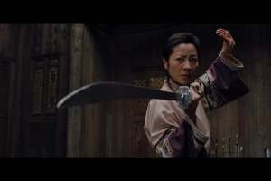 Actress Michelle Yeoh dons a sword in a fighting stance from a still as seen in "Crouching Tiger, Hidden Dragon" (2000)