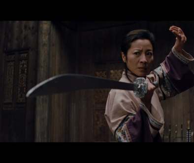 Actress Michelle Yeoh dons a sword in a fighting stance from a still as seen in "Crouching Tiger, Hidden Dragon" (2000)