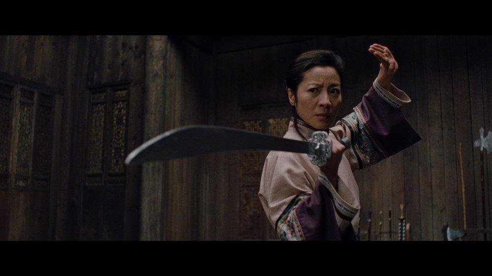 Actress Michelle Yeoh dons a sword in a fighting stance from a still as seen in "Crouching Tiger, Hidden Dragon" (2000)