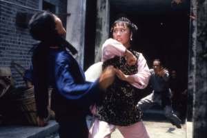 Angela Mao in an action movie still about to strike a henchman as seen in "Broken Oath" (1977)