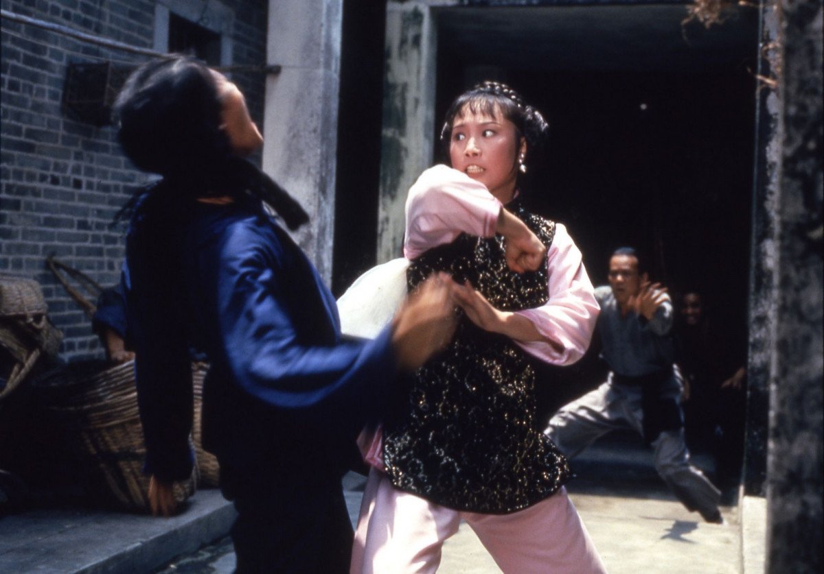 Angela Mao in an action movie still about to strike a henchman as seen in "Broken Oath" (1977)