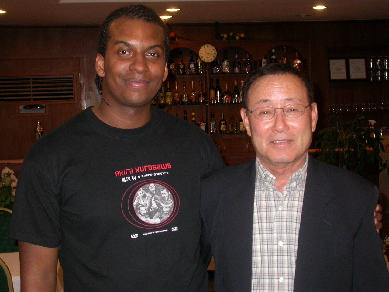 Two men stand next to each other for a picture in 2003