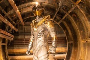 A heroic figure stands in a glowing white suit