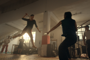 Two people fighting in a gym.