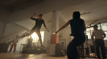 Two people fighting in a gym.