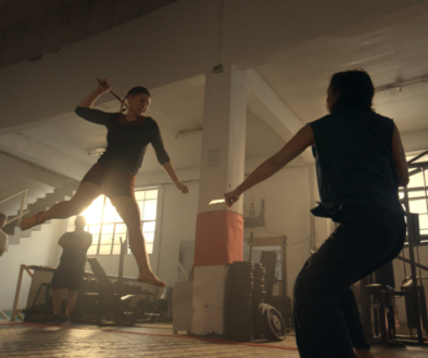 Two people fighting in a gym.