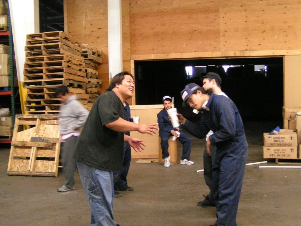 Five people laughing and having fun on a film set.