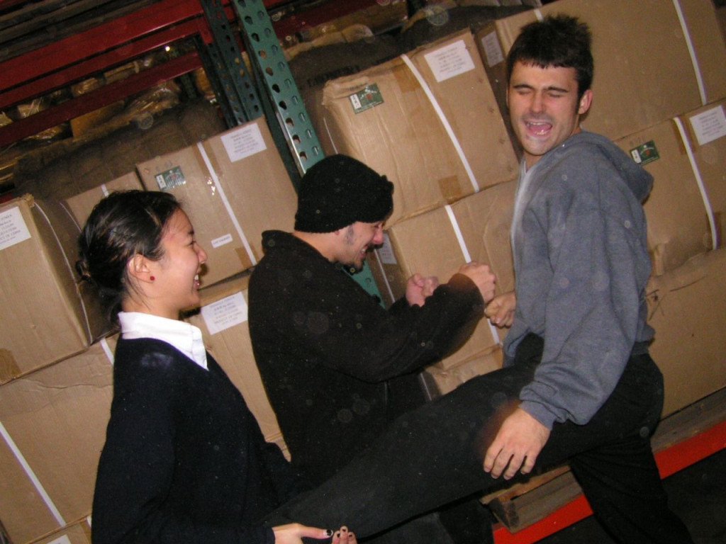 Three people laughing and having fun on an action movie set